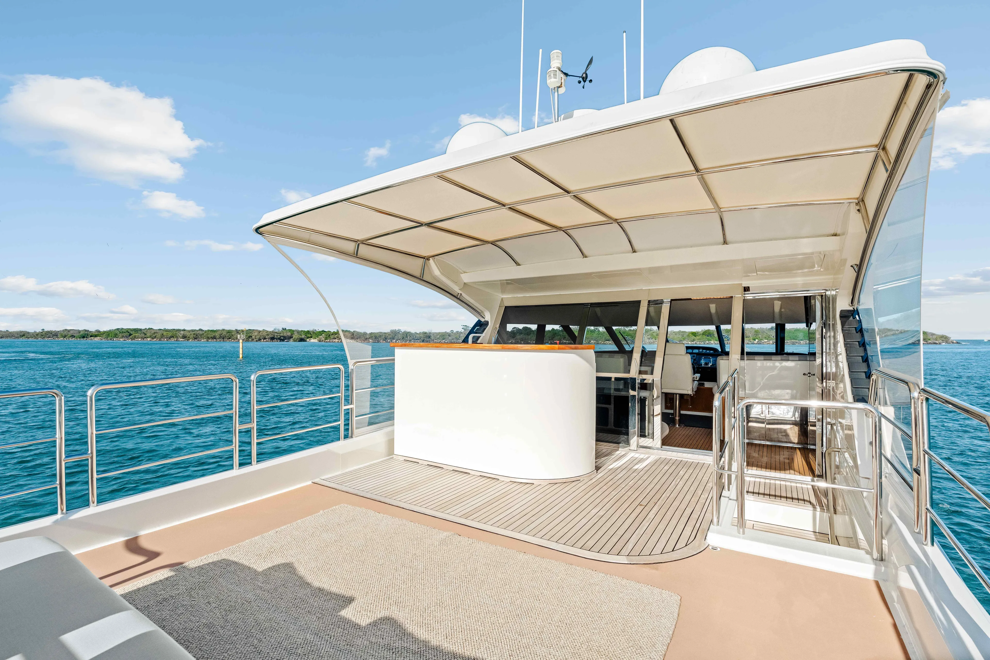 Infinite Yacht Photos Pics 1999 Warren Yachts 85 Motor Yacht deck with canopy, overlooking serene blue waters.