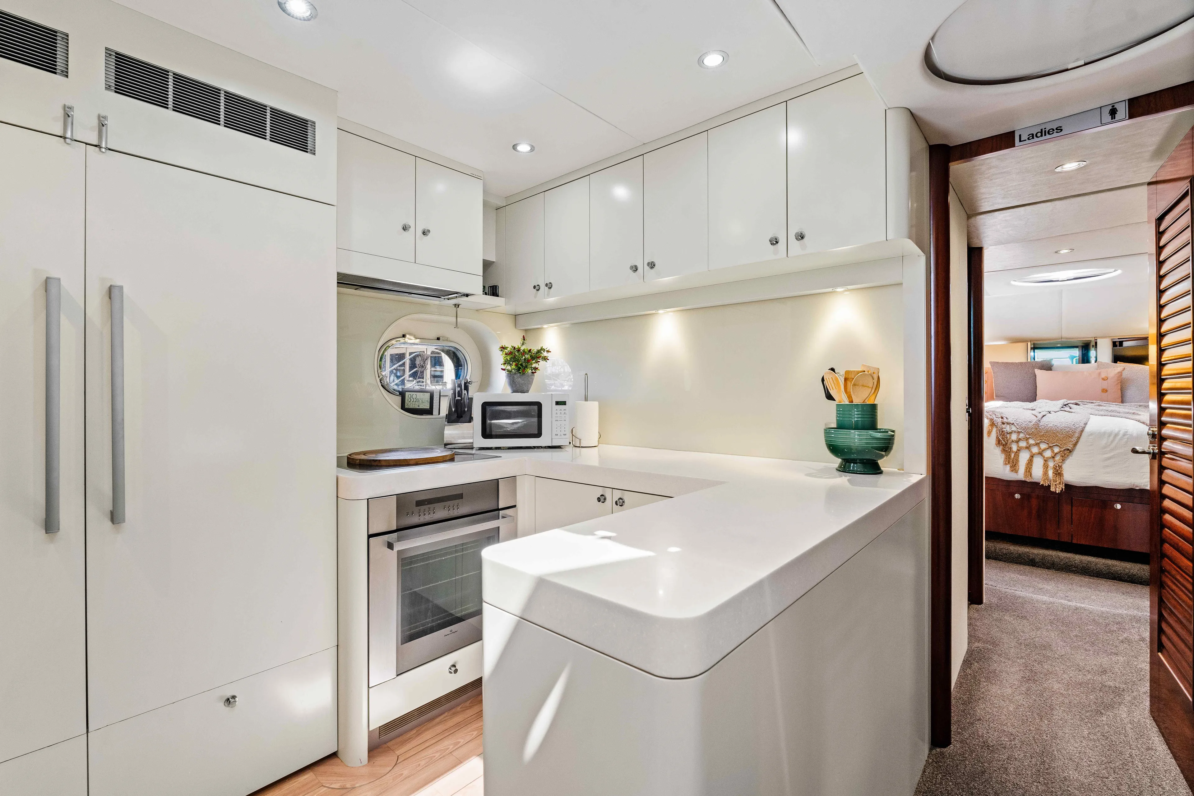 Infinite Yacht Photos Pics Luxurious kitchen interior of 1999 Warren Yachts 85 Motor Yacht, featuring modern appliances and sleek design.