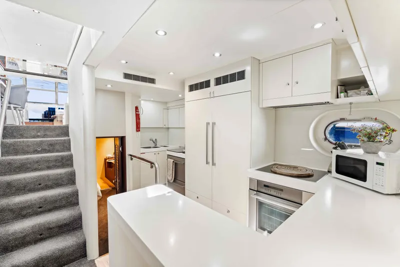 Infinite Yacht Photos Pics Luxurious kitchen interior of 1999 Warren Yachts 85 Motor Yacht, featuring modern appliances and sleek design.