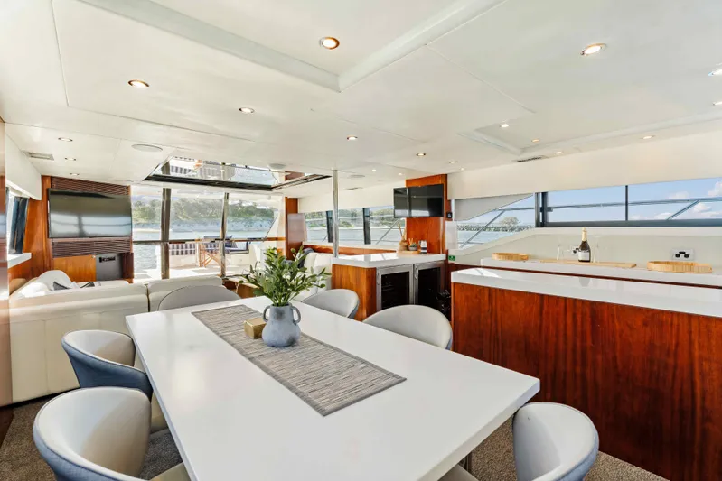 Infinite Yacht Photos Pics Luxurious interior of 1999 Warren Yachts 85 Motor Yacht with modern dining area and panoramic windows.