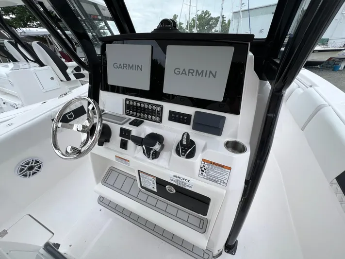  Yacht Photos Pics 2025 Sea Fox 288 Commander boat dashboard with dual Garmin displays and steering wheel.