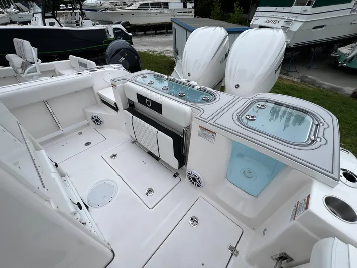  Yacht Photos Pics 2025 Sea Fox 288 Commander boat deck with dual engines and storage compartments.