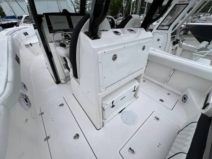  Yacht Photos Pics 2025 Sea Fox 288 Commander boat interior with white seating and Garmin navigation system.