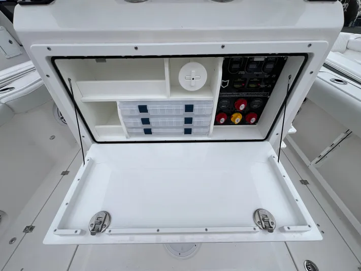  Yacht Photos Pics 2025 Sea Fox 288 Commander storage compartment with organized shelves and control panel.