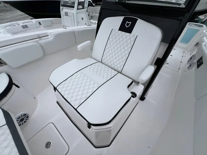  Yacht Photos Pics 2025 Sea Fox 288 Commander boat seat with white upholstery and black accents.