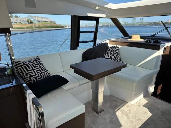 Meanwhile Yacht Photos Pics Luxurious interior of 2021 Prestige 420 S yacht with white leather seating and scenic water view.