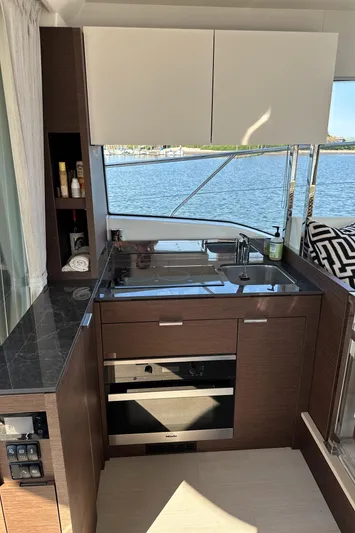 Meanwhile Yacht Photos Pics Modern kitchen area on a 2021 Prestige 420 S yacht with ocean view.