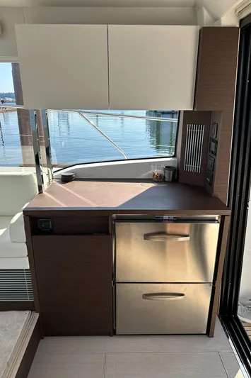Meanwhile Yacht Photos Pics Modern kitchen area on a 2021 Prestige 420 S yacht with stainless steel appliances.