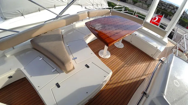  Yacht Photos Pics Luxury deck of 2004 Fairline Squadron 74 yacht with wooden table and seating.