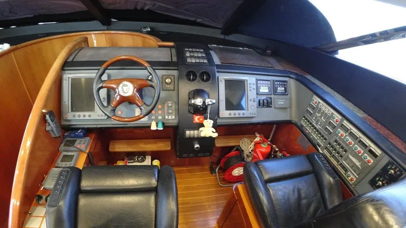  Yacht Photos Pics 2004 Fairline Squadron 74 yacht cockpit with leather seats and advanced navigation controls.