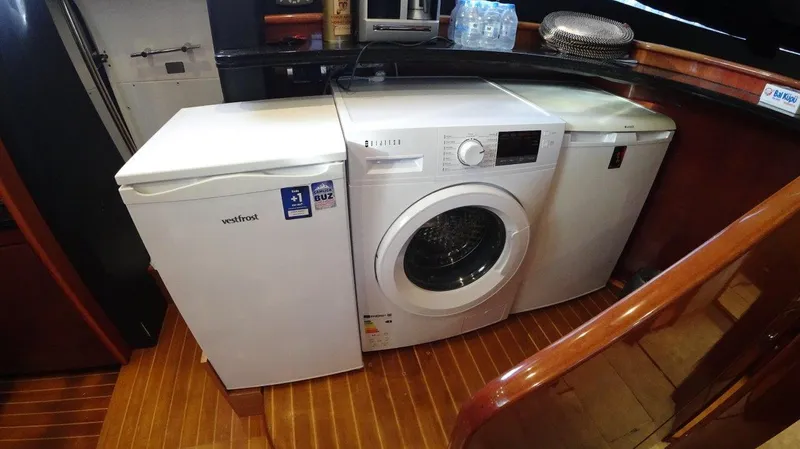  Yacht Photos Pics Laundry appliances on a 2004 Fairline Squadron 74 yacht with wooden flooring.
