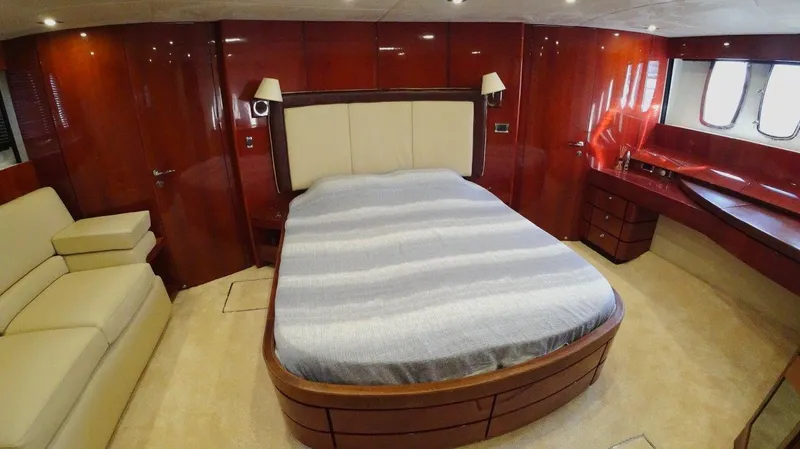  Yacht Photos Pics Luxurious bedroom interior of 2004 Fairline Squadron 74 yacht with elegant wood finishes.