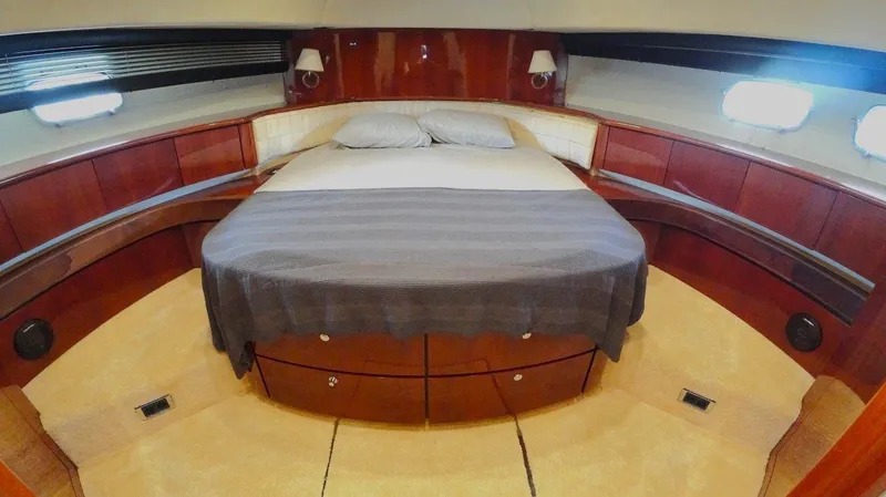  Yacht Photos Pics Luxurious cabin interior of 2004 Fairline Squadron 74 yacht with elegant wood finish.