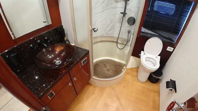  Yacht Photos Pics Luxurious bathroom in 2004 Fairline Squadron 74 yacht with modern fixtures and elegant design.