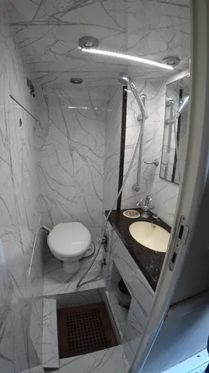  Yacht Photos Pics Luxurious bathroom in 2004 Fairline Squadron 74 yacht with marble design and modern fixtures.