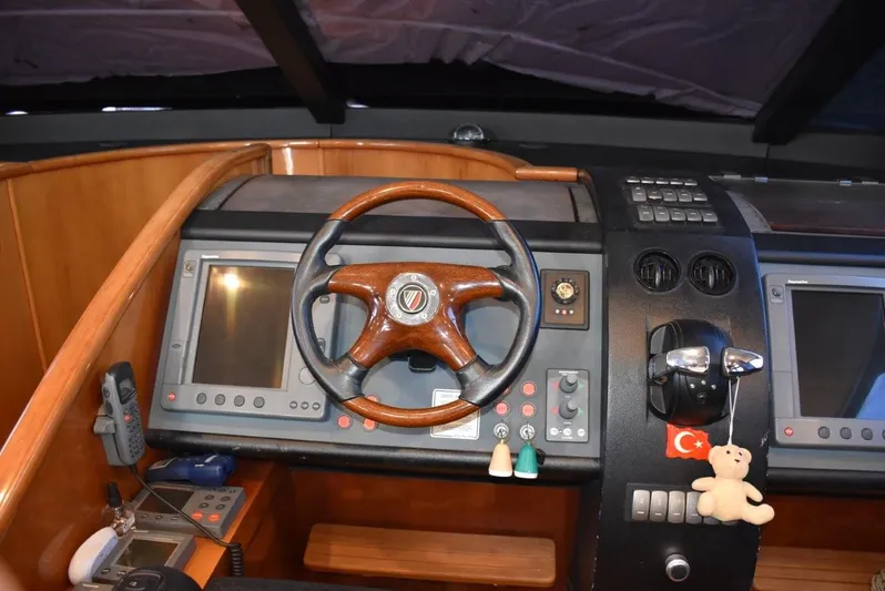  Yacht Photos Pics Helm of 2004 Fairline Squadron 74 yacht with wooden steering wheel and navigation screens.