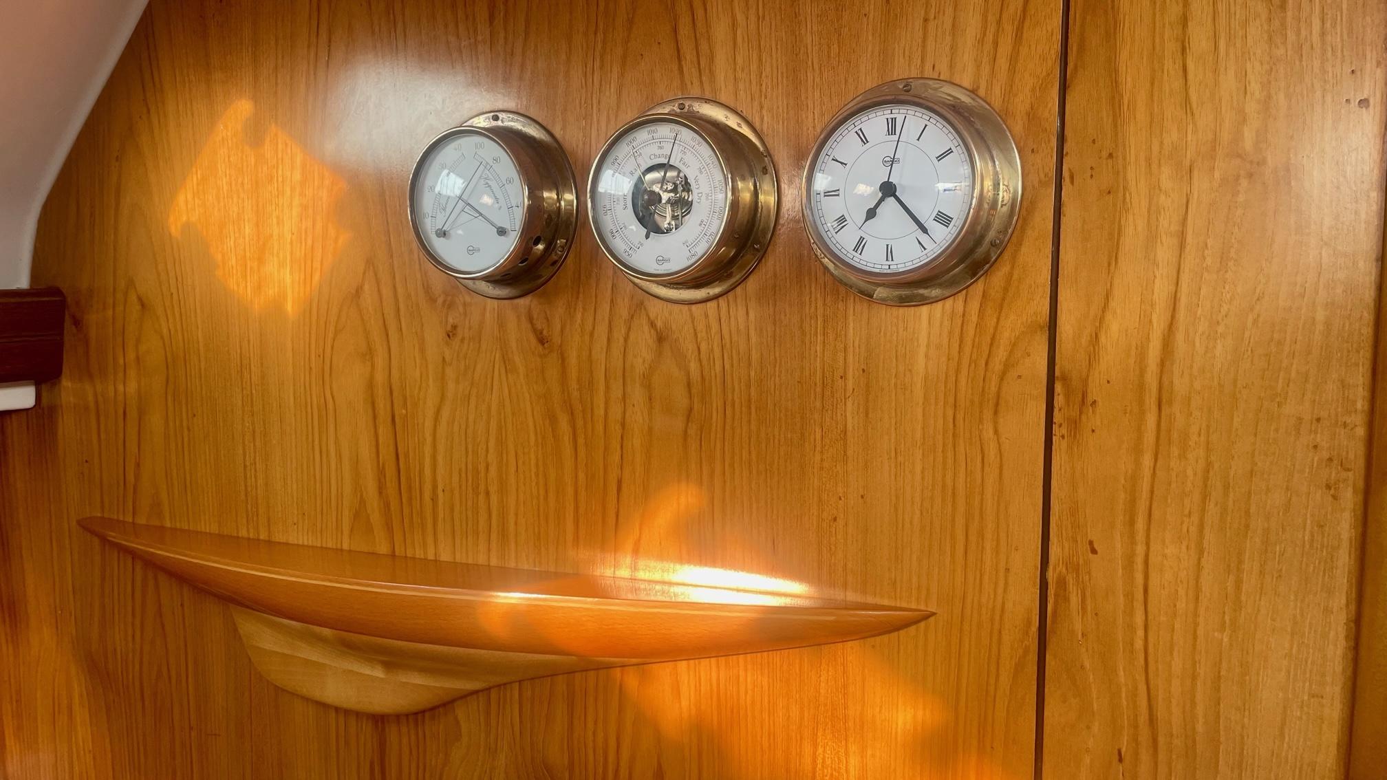 Wooden panel with three brass instruments on Alpha 51, 2003 model.