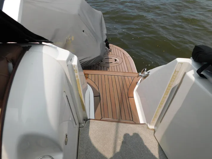  Yacht Photos Pics 2001 Sea Ray 510 Sundancer boat deck with wooden flooring, near water.