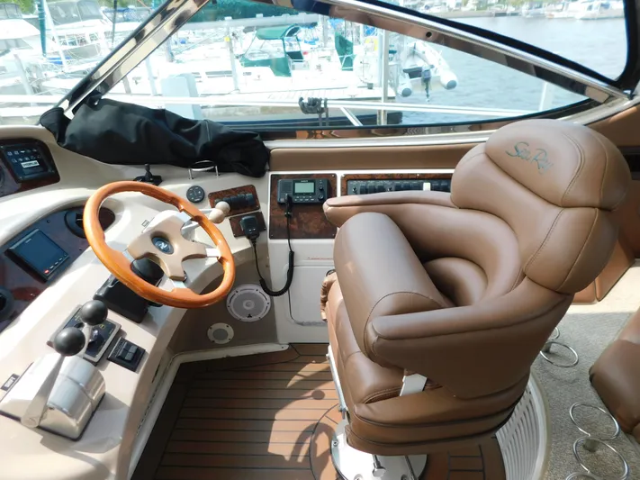  Yacht Photos Pics Helm of 2001 Sea Ray 510 Sundancer with leather captain's chair and wooden steering wheel.