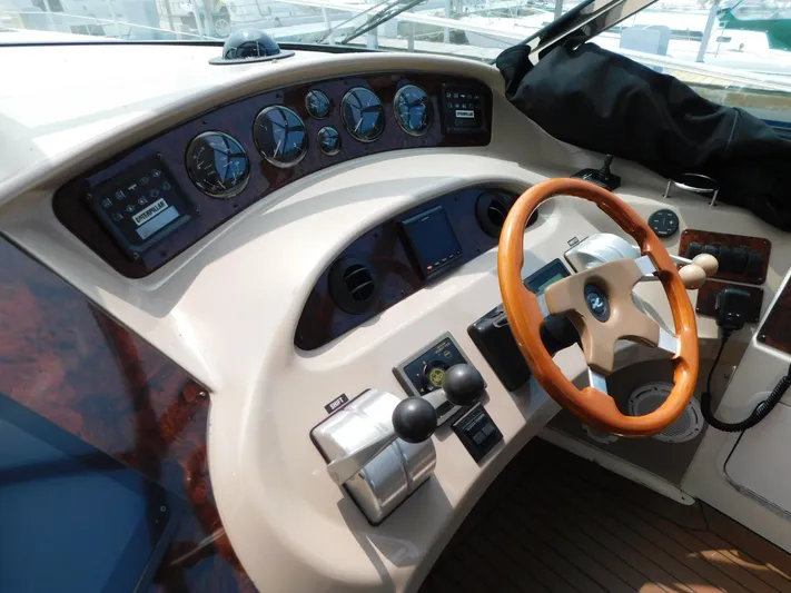  Yacht Photos Pics Helm of 2001 Sea Ray 510 Sundancer with wood-accented steering wheel and instrument panel.