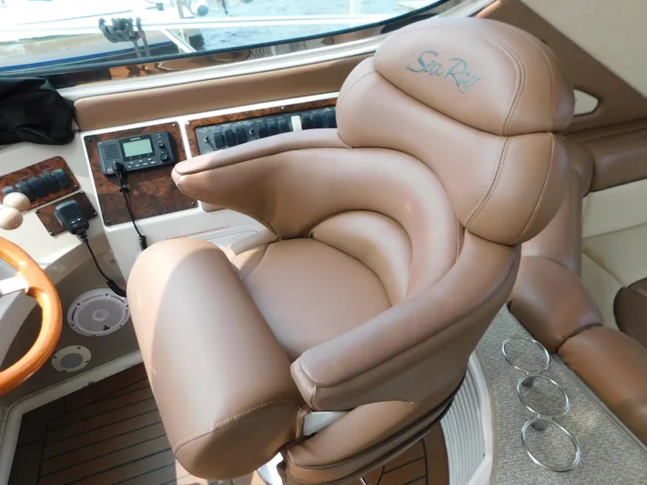  Yacht Photos Pics Luxurious captain's chair on 2001 Sea Ray 510 Sundancer yacht, featuring plush leather upholstery.