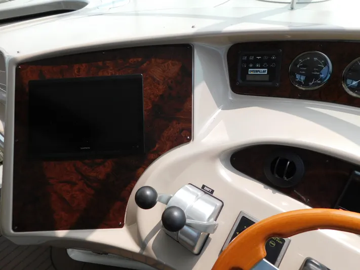  Yacht Photos Pics Control panel of a 2001 Sea Ray 510 Sundancer yacht with gauges and steering wheel.