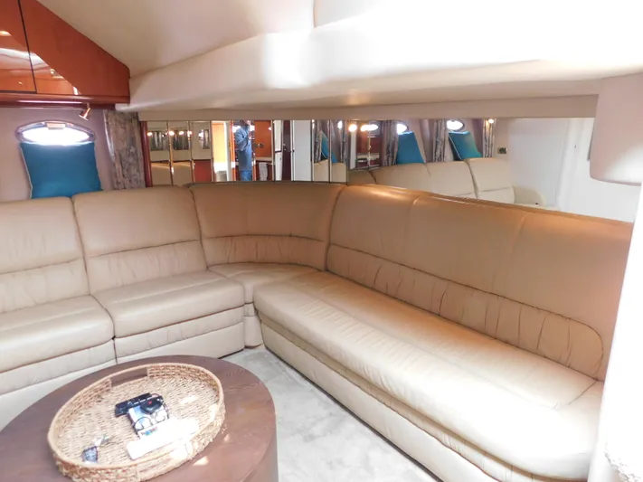  Yacht Photos Pics Luxurious interior of 2001 Sea Ray 510 Sundancer with beige leather seating and elegant decor.