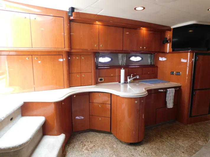  Yacht Photos Pics Luxurious kitchen interior of 2001 Sea Ray 510 Sundancer yacht with wooden cabinetry.