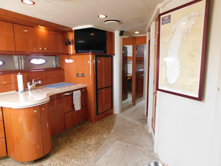  Yacht Photos Pics Interior of 2001 Sea Ray 510 Sundancer yacht with wood cabinetry and map on wall.