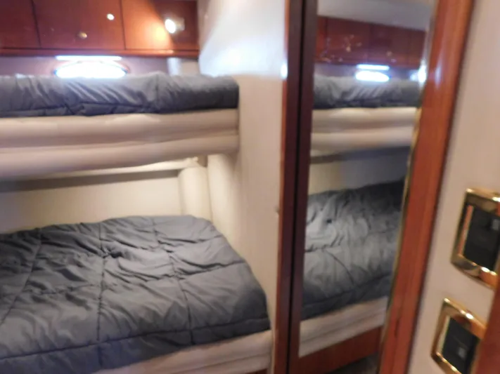  Yacht Photos Pics Interior of 2001 Sea Ray 510 Sundancer with bunk beds and wooden cabinetry.
