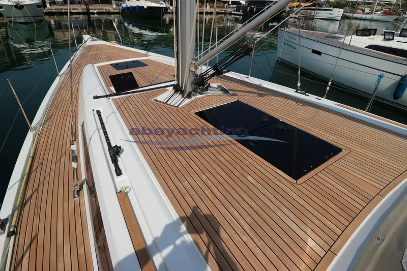  Yacht Photos Pics Grand Soleil 46 LC 2016 yacht with sleek teak deck in marina setting.