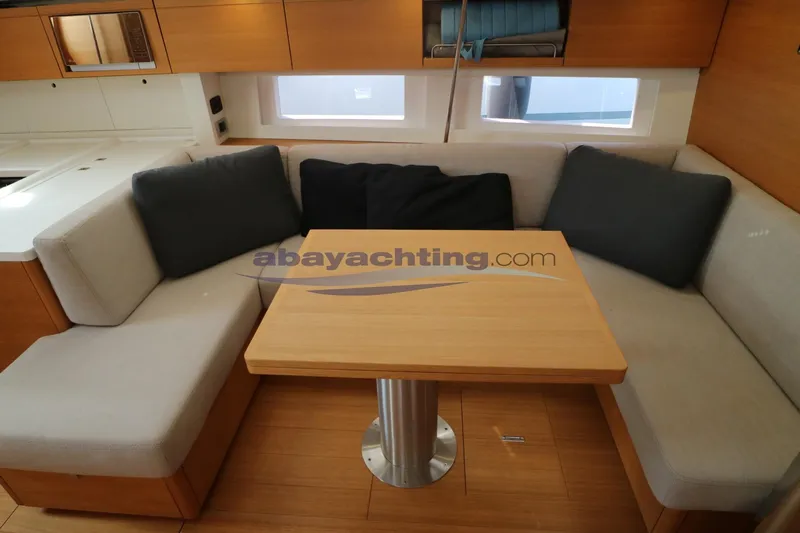  Yacht Photos Pics Interior of 2016 Grand Soleil 46 LC yacht with cozy seating and wooden table.