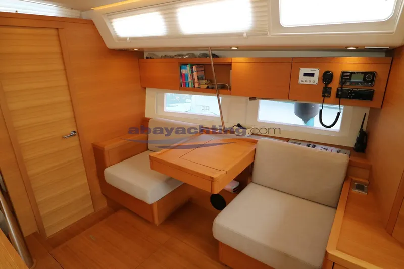  Yacht Photos Pics Interior of 2016 Grand Soleil 46 LC yacht with wooden furnishings and seating area.