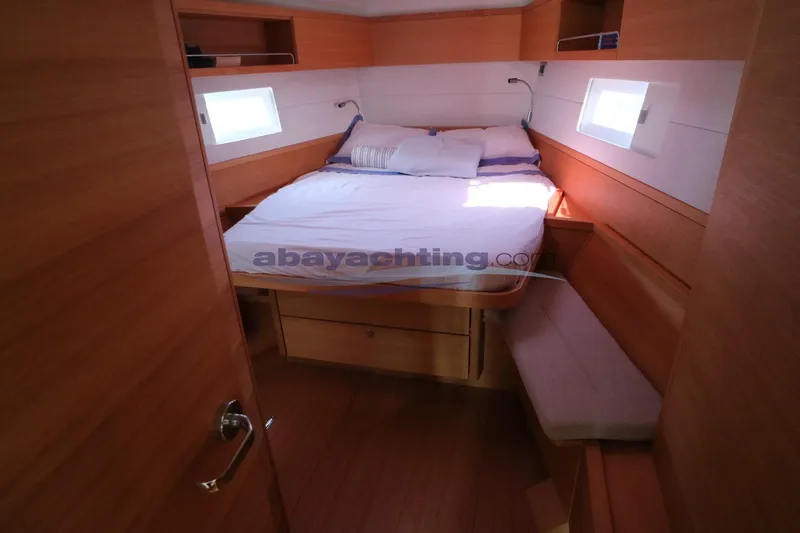  Yacht Photos Pics Cozy cabin interior of 2016 Grand Soleil 46 LC yacht with wooden finish and bed.