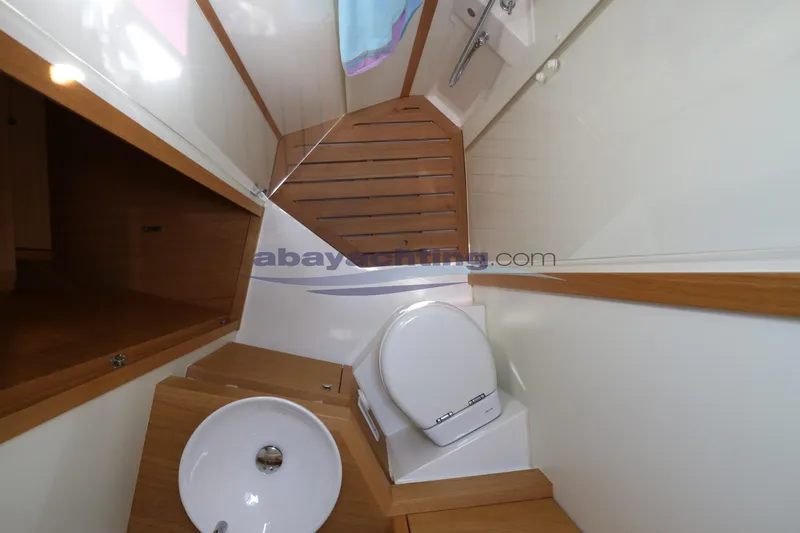  Yacht Photos Pics Bathroom interior of 2016 Grand Soleil 46 LC yacht with wooden accents and modern fixtures.