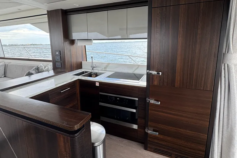 4 Play Yacht Photos Pics Luxurious kitchen interior of 2022 Sunseeker Manhattan 68 yacht with ocean view.