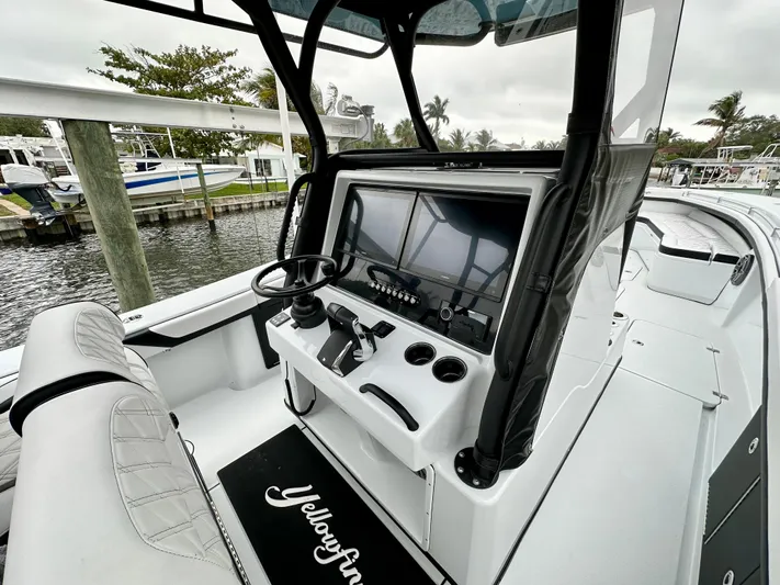  Yacht Photos Pics 2024 Yellowfin 36 boat console with steering wheel and navigation system.
