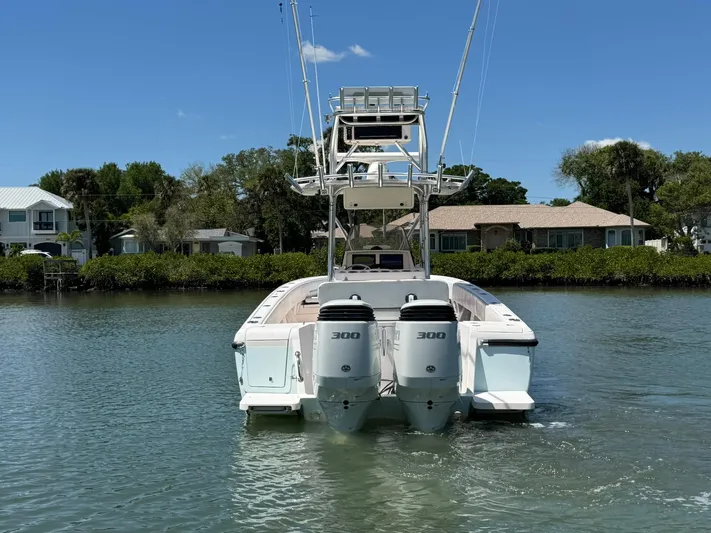  Yacht Photos Pics 2006 Intrepid 323 boat with dual 300 horsepower engines on calm water.