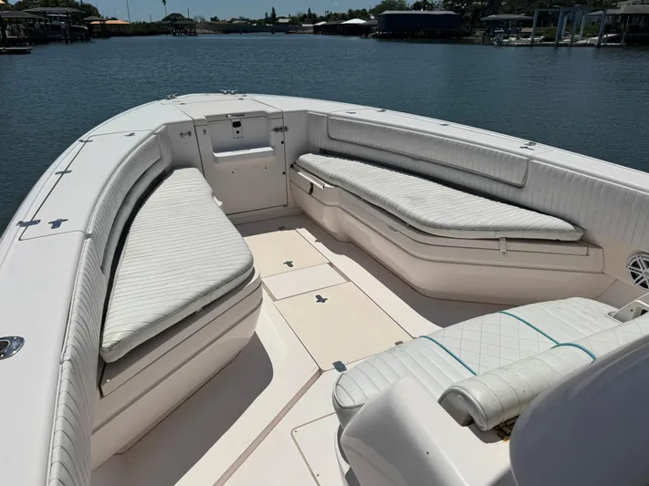  Yacht Photos Pics 2006 Intrepid 323 boat interior with white cushioned seating on a calm waterway.