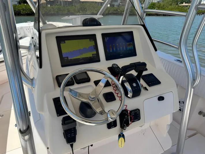  Yacht Photos Pics 2006 Intrepid 323 boat dashboard with navigation screens and steering wheel.