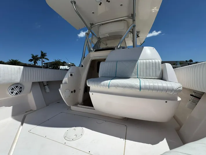  Yacht Photos Pics 2006 Intrepid 323 boat interior with white seating and clear blue sky background.