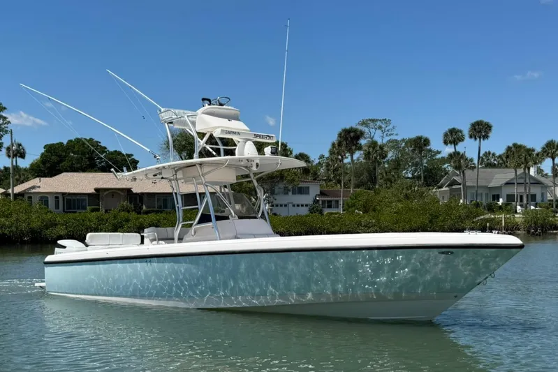  Yacht Photos Pics 2006 Intrepid 323 boat on calm water with clear blue sky background.