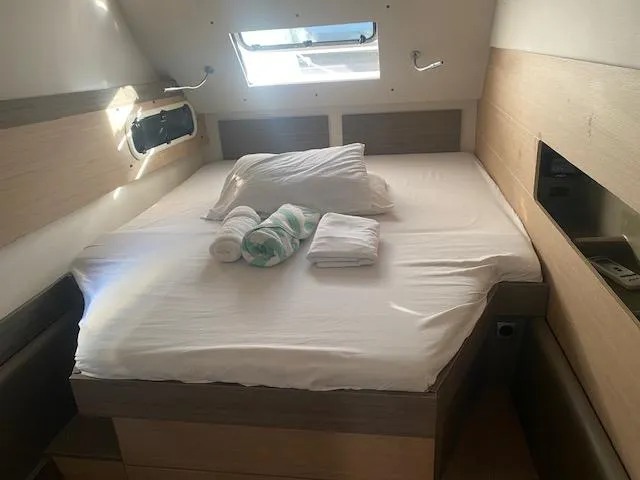 Yacht Photos Pics Cozy cabin bedroom in 2017 Bali 4.0 yacht with skylight and neatly arranged linens.