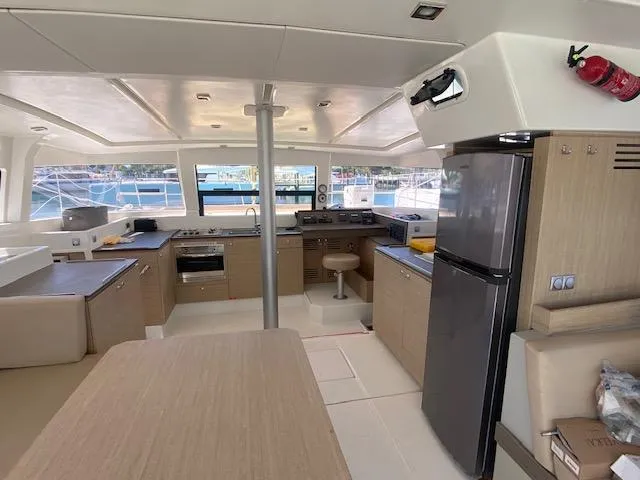  Yacht Photos Pics Modern kitchen and dining area inside a 2017 Bali 4.0 catamaran yacht.