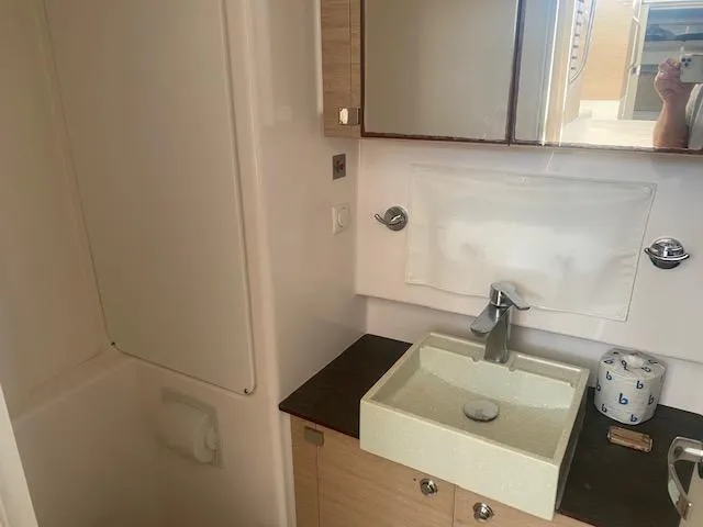  Yacht Photos Pics Modern bathroom in a 2017 Bali 4.0 yacht with sink, mirror, and storage.