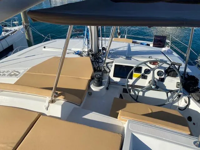  Yacht Photos Pics Helm station of 2017 Bali 4.0 catamaran with tan cushions and modern navigation equipment.