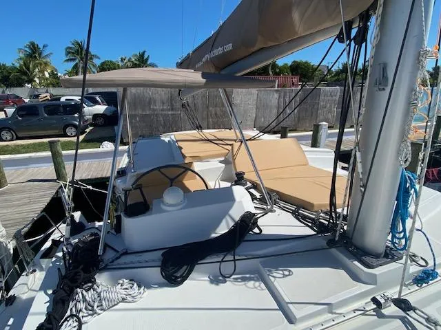 Yacht Photos Pics 2017 Bali 4.0 catamaran docked, featuring helm station and sunbathing area.