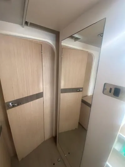  Yacht Photos Pics Modern interior of a 2017 Bali 4.0 yacht with wooden doors and a large mirror.