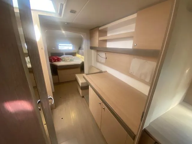  Yacht Photos Pics Interior of 2017 Bali 4.0 yacht with modern wooden cabinetry and cozy sleeping area.