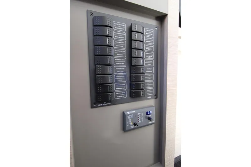  Yacht Photos Pics Control panel of 2021 Fountaine Pajot Astrea 42 yacht, featuring labeled switches and digital display.